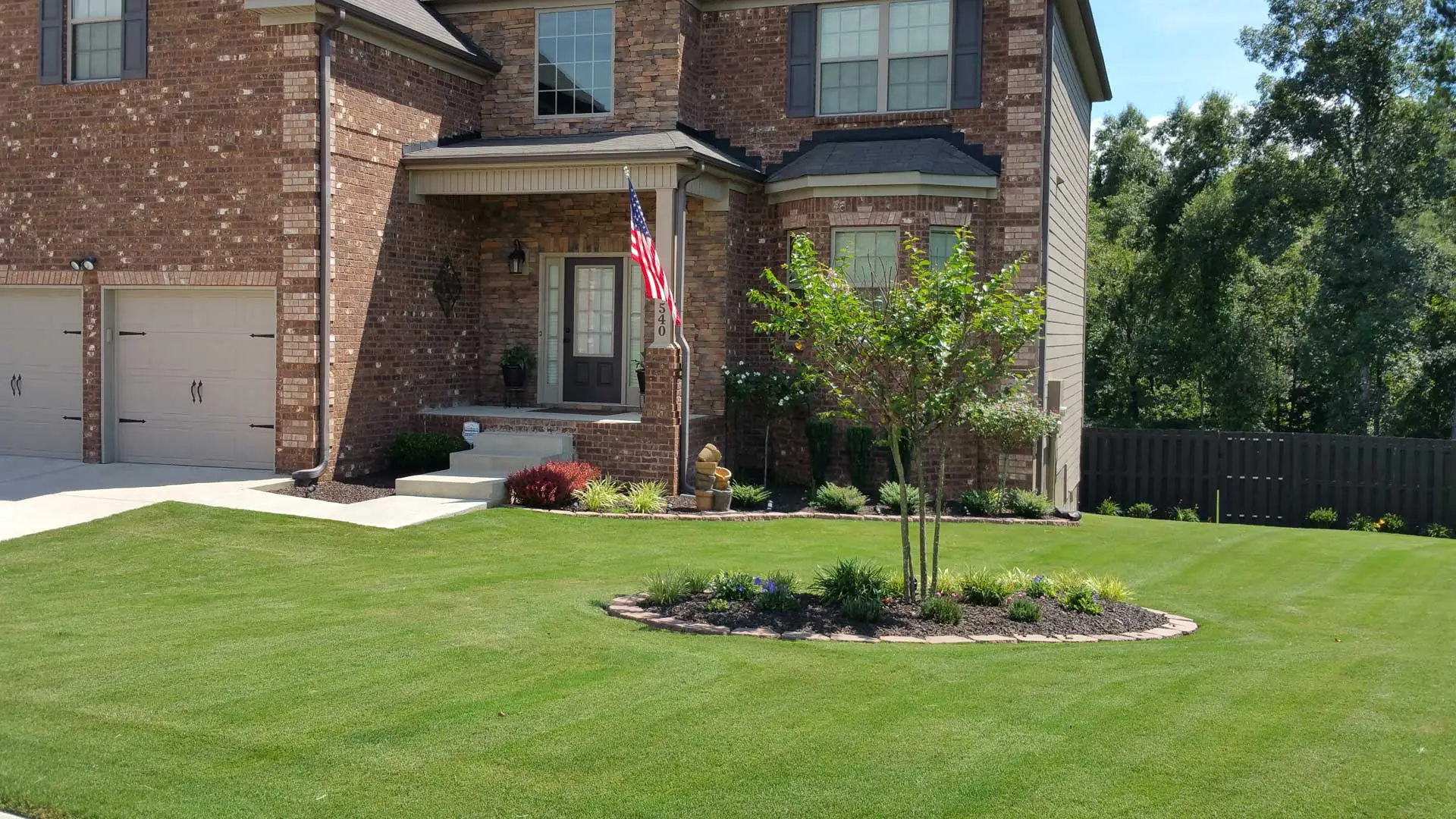 Perfectly trimmed shrubs and bushes at a home in Evans with frequent landscape maintenance.