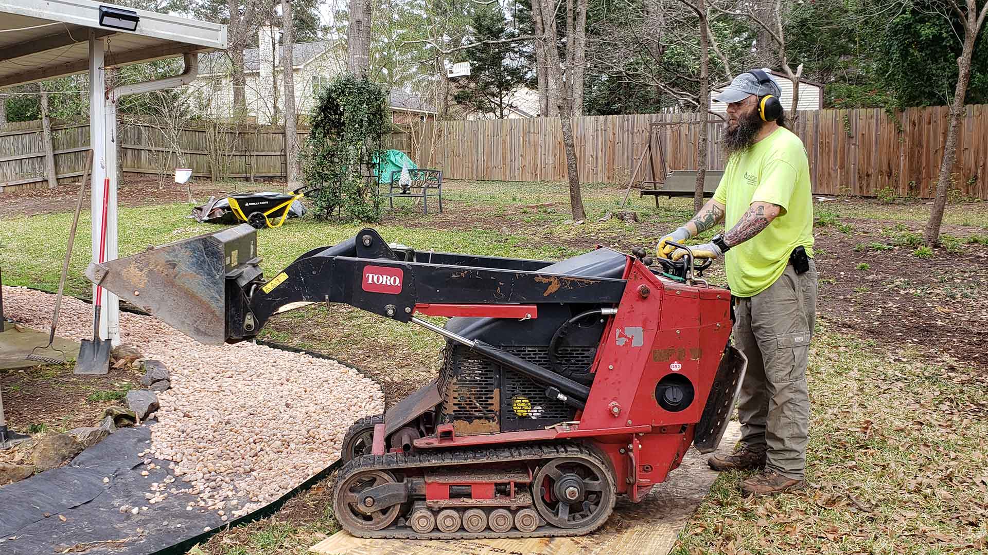 Using a mini skid steer to install gravel at a home in Martinez, GA.
