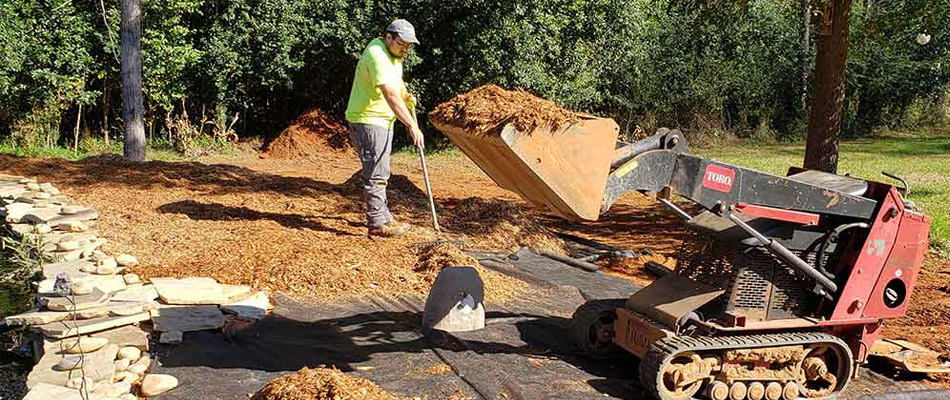 Creating a gravel pathway with our mini skid steer in Evans, GA.